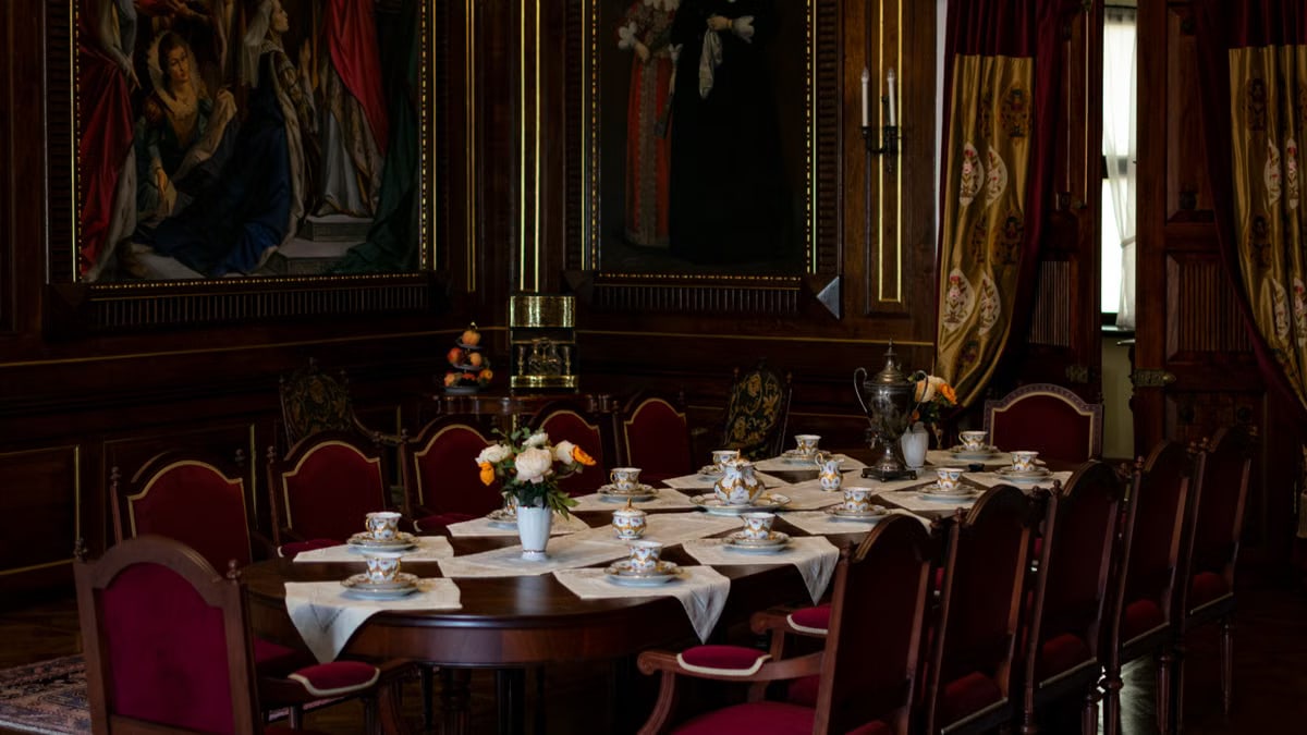 Luxurious dining room setup with vintage decor and fine china in Nesvizh Castle, Belarus.